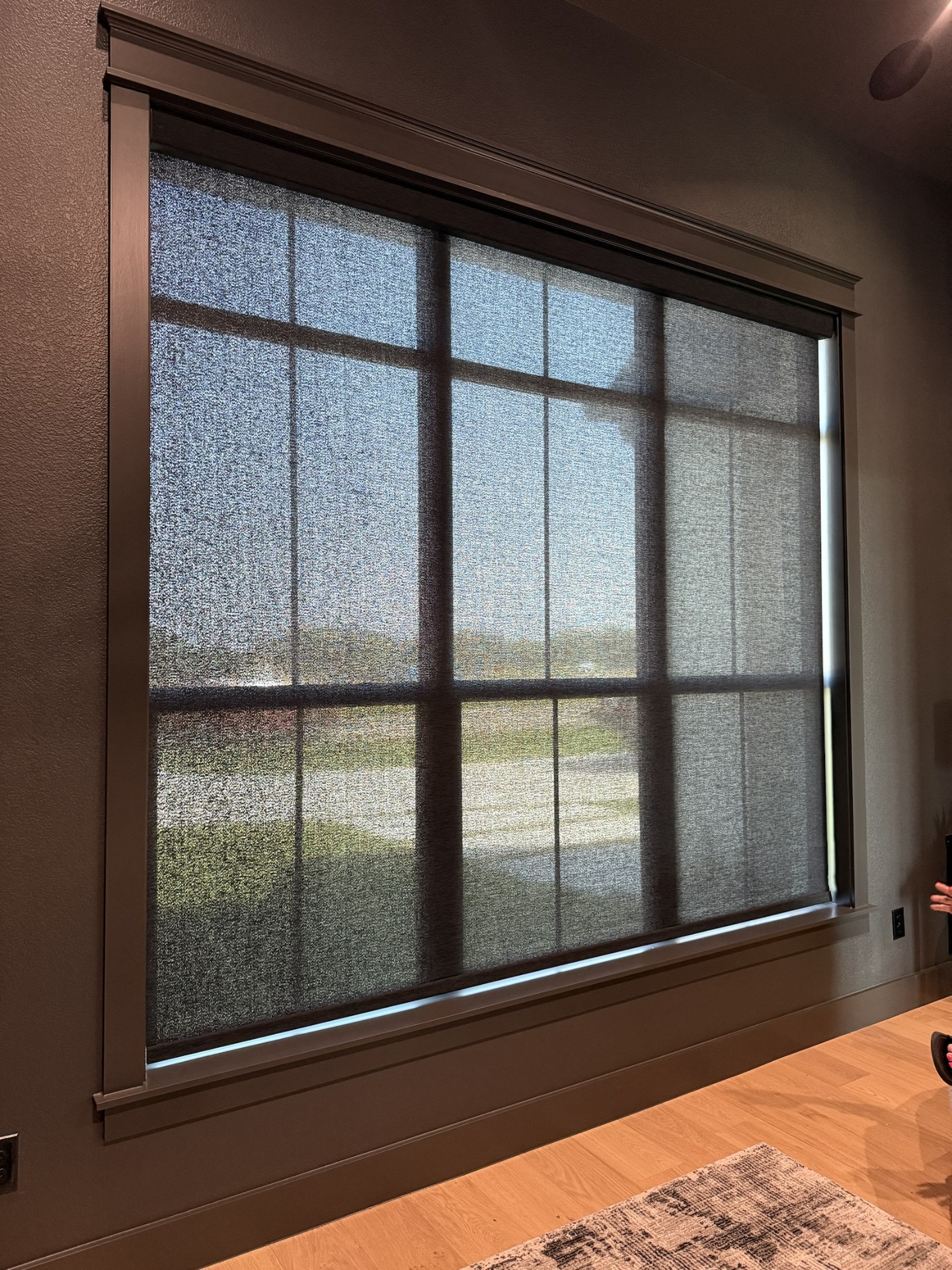 Large picture window with dark solar shade