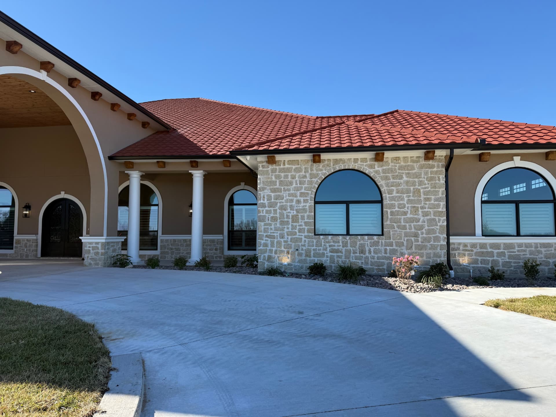 Spanish style home with arched windows and Optex solar screens