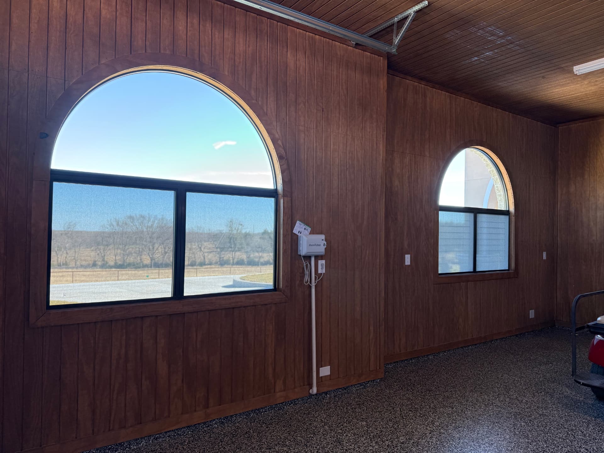 Interior view of arched garage windows with Optex solar screens