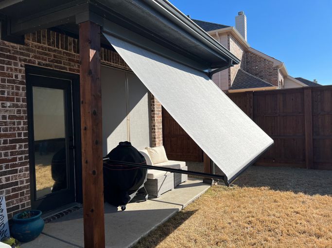 Retractable exterior awning over backyard patio